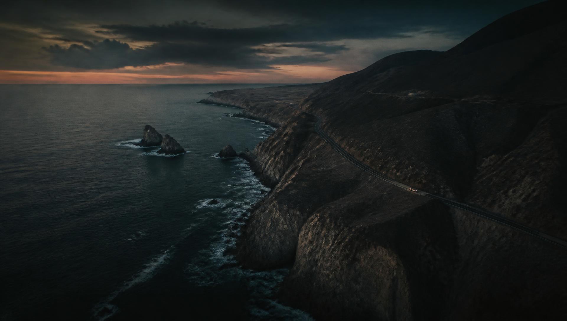 Aerial view of a coastal highway captured at dusk